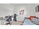 Versatile bedroom space, featuring a gray trundle bed with a desk and exercise equipment at 5857 Beefmaster Rd, St Cloud, FL 34771