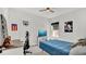 Contemporary bedroom with a blue bed, desk area, and entertainment setup at 5857 Beefmaster Rd, St Cloud, FL 34771