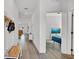 Bright hallway featuring wood flooring and a view into a living room and a bedroom at 5857 Beefmaster Rd, St Cloud, FL 34771