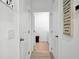 Bright hallway with neutral paint, leading to a laundry room and additional rooms at 5857 Beefmaster Rd, St Cloud, FL 34771