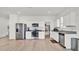 Well-lit kitchen with stainless steel appliances, white cabinets, and granite countertops at 5857 Beefmaster Rd, St Cloud, FL 34771