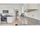 Stylish kitchen featuring granite countertops, stainless steel sink, and ample storage space at 5857 Beefmaster Rd, St Cloud, FL 34771