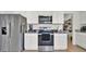 Modern kitchen with stainless steel appliances and white cabinetry, designed for functionality at 5857 Beefmaster Rd, St Cloud, FL 34771