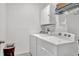 Functional laundry room with white appliances, storage, and shelving for organization at 5857 Beefmaster Rd, St Cloud, FL 34771