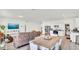 Bright living area with a wood dining table and a view of the modern kitchen at 5857 Beefmaster Rd, St Cloud, FL 34771