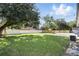 Expansive backyard featuring lush green grass and a white vinyl fence for added privacy at 606 Faber Dr, Orlando, FL 32822