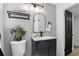 Stylish bathroom featuring a modern vanity, arched mirror, and decorative plant for a spa-like feel at 606 Faber Dr, Orlando, FL 32822
