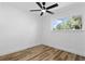 Bright bedroom featuring wood-look floors, a ceiling fan, and a window with serene views at 606 Faber Dr, Orlando, FL 32822