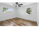 Well-lit bedroom with sleek wood-look floors, bright white walls, and windows offering outdoor views at 606 Faber Dr, Orlando, FL 32822