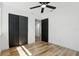 Cozy bedroom boasts wood-look floors and black closet doors for a modern aesthetic at 606 Faber Dr, Orlando, FL 32822