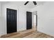 This bedroom has black doors, wood-look floors, and a ceiling fan at 606 Faber Dr, Orlando, FL 32822