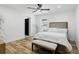 Serene bedroom with ceiling fan, neutral decor, and bench at the foot of the bed at 606 Faber Dr, Orlando, FL 32822