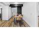 Cozy dining area featuring wood floors, modern table and chairs, and stylish black design elements at 606 Faber Dr, Orlando, FL 32822