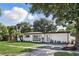 Charming single-story home with fresh white paint, landscaped yard and stylish gray window shutters at 606 Faber Dr, Orlando, FL 32822