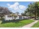 Charming single-story home with fresh white paint, landscaped yard and stylish gray window shutters at 606 Faber Dr, Orlando, FL 32822
