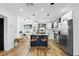 Stylish kitchen with white cabinetry, butcher block island, and stainless steel appliances at 606 Faber Dr, Orlando, FL 32822