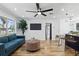 Bright living room with modern decor, sleek ceiling fan, and hardwood floors, open floor plan at 606 Faber Dr, Orlando, FL 32822