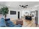 Inviting living room with a comfortable blue sofa and open layout to the kitchen at 606 Faber Dr, Orlando, FL 32822