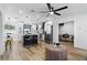 Bright living room open floor plan with modern decor, hardwood floors, and view into kitchen and dining room at 606 Faber Dr, Orlando, FL 32822