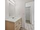 Clean bathroom featuring a single vanity, updated light fixture, and an open doorway at 6088 Westgate Dr # 201, Orlando, FL 32835