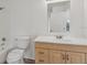 Clean bathroom with a wooden vanity, modern fixtures, and a well-lit mirror perfect for a cozy home at 6088 Westgate Dr # 201, Orlando, FL 32835