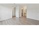 Spacious bedroom featuring hardwood floors and doorways to a closet and the bathroom at 6088 Westgate Dr # 201, Orlando, FL 32835