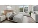 Cozy bedroom featuring a plush bed, modern decor, and bright windows for natural light at 6088 Westgate Dr # 201, Orlando, FL 32835