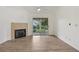 Bright living room boasts hardwood floors, fireplace, and sliding glass doors to the outside at 6088 Westgate Dr # 201, Orlando, FL 32835