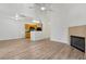 Open-concept living area with hardwood floors, a fireplace, and a view into the adjacent kitchen at 6088 Westgate Dr # 201, Orlando, FL 32835