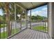 Screened porch with lovely views of palm trees, offering a serene outdoor retreat for relaxation at 6088 Westgate Dr # 201, Orlando, FL 32835