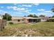 View of the backyard and the screened in porch on the back of the home at 622 N Goodrich Dr, Deltona, FL 32725