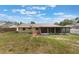 View of the backyard and the screened in porch on the back of the home at 622 N Goodrich Dr, Deltona, FL 32725