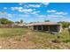 Expansive backyard featuring a screened lanai, partially fenced yard, and sunny sky at 622 N Goodrich Dr, Deltona, FL 32725