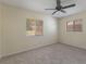 Bright bedroom with carpet, ceiling fan, and two windows letting in natural light at 622 N Goodrich Dr, Deltona, FL 32725