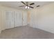 Bedroom featuring neutral carpet, a ceiling fan, closet, window, and neutral paint at 622 N Goodrich Dr, Deltona, FL 32725
