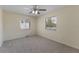Bedroom featuring two windows, a ceiling fan and neutral carpet and paint at 622 N Goodrich Dr, Deltona, FL 32725