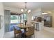 Cozy dining area with modern chandelier and sliding door access to the screened lanai at 622 N Goodrich Dr, Deltona, FL 32725