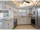 Well-lit kitchen boasts stainless steel appliances and white cabinets at 622 N Goodrich Dr, Deltona, FL 32725