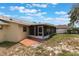 Back patio with screened lanai and small brick-laid landing at 622 N Goodrich Dr, Deltona, FL 32725