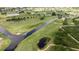 Scenic aerial view of a golf course surrounded by water, including ponds and lush greenery at 6741 Heavitree Dr, Sebring, FL 33876