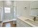 Modern bathroom with a glass-enclosed shower, marble-look tile, and a white vanity at 6741 Heavitree Dr, Sebring, FL 33876