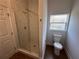Modern bathroom featuring a shower with glass door, toilet, window, and a vanity with quartz countertop at 6741 Heavitree Dr, Sebring, FL 33876