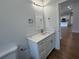 Bathroom features a white vanity, quartz countertops and chrome plumbing fixtures at 6741 Heavitree Dr, Sebring, FL 33876