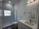Modern bathroom featuring a walk-in shower, toilet, vanity with white cabinets and quartz countertop at 6741 Heavitree Dr, Sebring, FL 33876