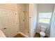 Bathroom featuring a walk-in shower with glass door, a toilet, and a window at 6741 Heavitree Dr, Sebring, FL 33876