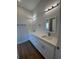 Bathroom features double sinks with modern fixtures, a vanity and quartz countertops at 6741 Heavitree Dr, Sebring, FL 33876