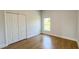 Bedroom featuring light-colored walls and a large closet with wood-style floors at 6741 Heavitree Dr, Sebring, FL 33876