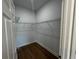 Interior view of an empty closet with wire shelves and wood floors at 6741 Heavitree Dr, Sebring, FL 33876