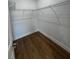 Walk-in closet with wood floors, white walls, and wire shelving installed around the perimeter at 6741 Heavitree Dr, Sebring, FL 33876