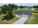 Beautifully landscaped single-Gathering home with a well-manicured lawn and a gray brick driveway at 6741 Heavitree Dr, Sebring, FL 33876